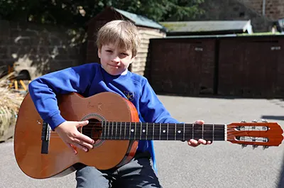 Child playing guitar<br />
